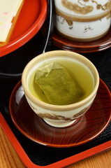 Green tea bag in the cup 
