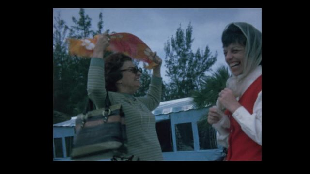 1968 Strong wind blowing 2 women with head scarves