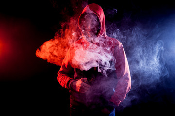 Man vaping an electronic cigarette.Isolated on black background