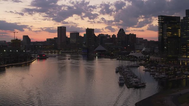 Baltimore, Maryland circa-2017, Flying up inner harbor to downtown Baltimore at sunset.   Shot with Cineflex and RED Epic-W Helium. 