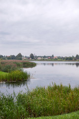 Fototapeta na wymiar September lake landscape with cottages on the horizon in Liksna, village in Daugavpils Municipality in southeastern Latvia