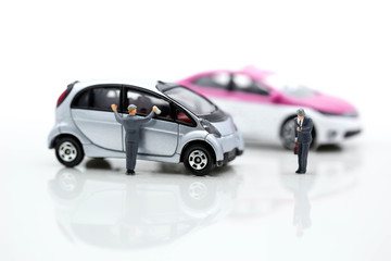 Miniature people: Worker cleaning car and businessman look a watch using as background business concept.