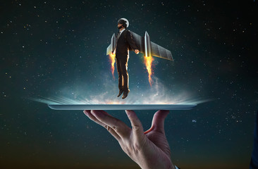 Waiter hand holding an empty digital tablet with Businessman wear a rocket suit to lift , Business...