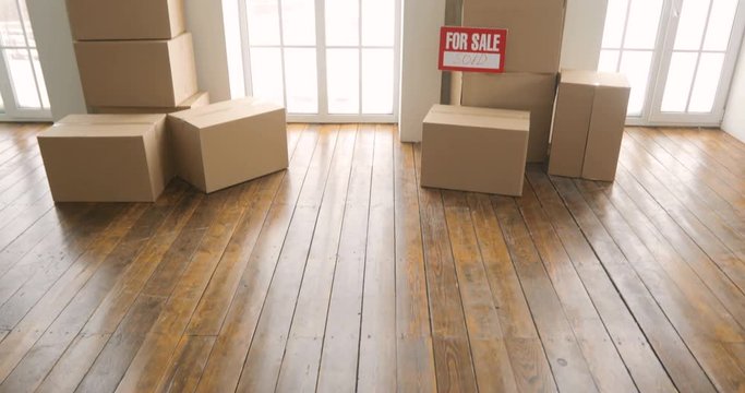 New home owners unpacking boxes. moving day concept. big cardboard boxes in new home