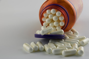  Color Bottle of white pills on a white background.