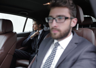 business people sitting in car