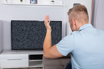 Man In Front Of Television With No Signal
