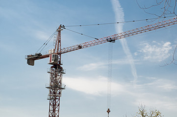 red tower crane on the sky background.