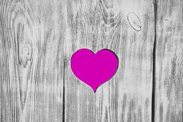White heart carved in a wooden board. Background.