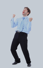 One very happy energetic businessman with his arms raised.