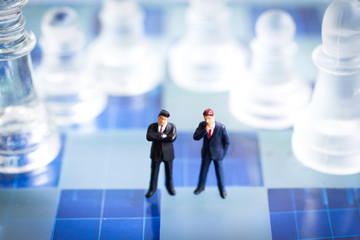 Miniature people, Two Businessmen standing on the chess game, thinking solution for the business game,  use as a business competition concept.