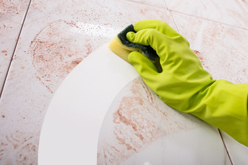 Hands In Rubber Gloves Scrubbing Kitchen