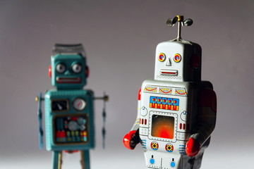 Naklejka premium Angry vintage tin toy robots, artificial intelligence, robotic drone delivery concept