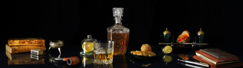 Panorama still life with whiskey and antique objects in retro style