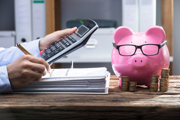Businessperson's Hand Calculating Bill