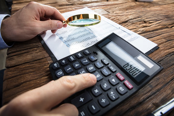 Businessman's Hand Calculating Financial Report