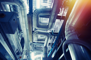 Equipment, cables and piping as found inside of a modern industrial power plant
