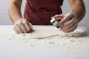 cropped image of chef preparing heart shaped cookies with dough mold, valentines day concept