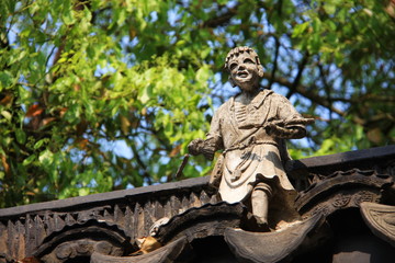 Stone Statue on the roof of chinese building. Travel in Suzhou City, China in 2009 April 17th.