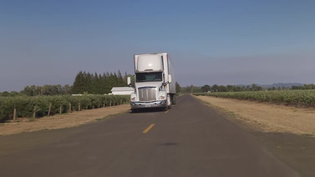Semi truck driving on rural road.  Fully released for commercial use.