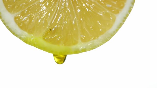 citron with dripping clear juice on white background
