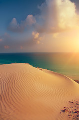 beautiful view of the sunset at the sea with a sand dune. Sea calm sunset view.
