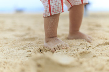 A baby legs on a beach