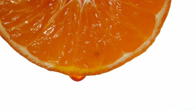 mandarin with dripping clear juice on white background