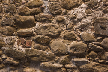 Stone wall background and ancient tuff, Tuscany in Italy