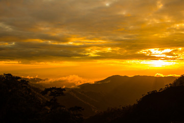 Photo landscape and sunset.The Sunset on the mountains. High  Mountain in chaingrai  province Thailand.