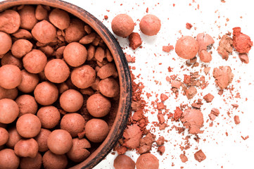 Crushed makeup on white background