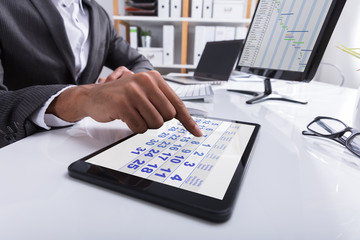 Businessperson Using Calendar On Digital Tablet