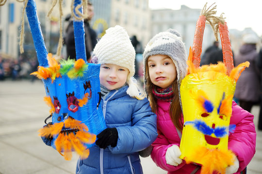 Two cute girls wearing frightening masks during the celebration of Uzgavenes, a Lithuanian annual folk festival taking place seven weeks before Easter.