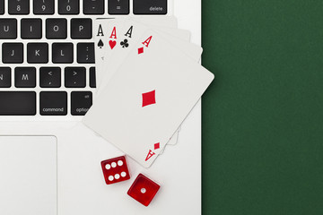 Online gambling. Playing cards and dice on a computer keyboard