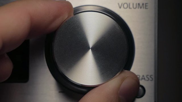 The man adjusts the volume