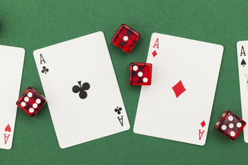 Poker cards and dice on a green background.