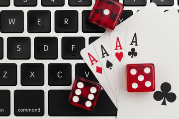 Online gambling. Playing cards and dice on a computer keyboard