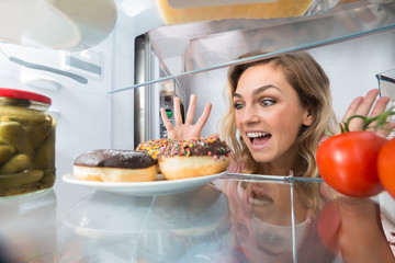 Young Woman Looking At Donuts