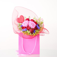Romantic Valentine's Day bouquet with a heart in a paper pink bag