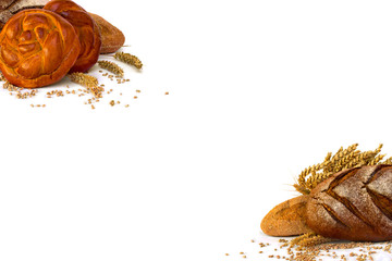 Assorted different fresh baked bread, dark and white whole grain loaves, wheat ears and wheat grain on a white background with space of text.