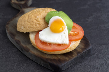 Breakfast on Valentine's day. sandwich with egg and avocado.