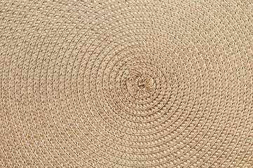 A colored mat made of rope twirled into a spiral.