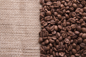 Coffee beans on burlap texture background