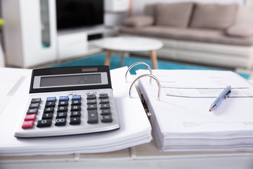 Close-up Of Calculator And Documents