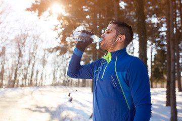 Male refreshes with water after running