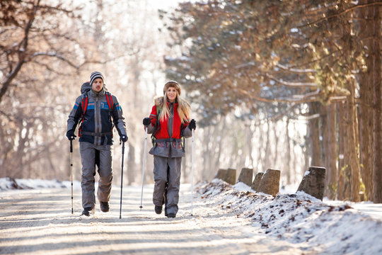 Couple of mountaineers hiking on winter