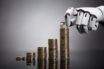 Robot Stacking Coins On Grey Background