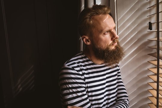 Thoughtful Man Watching Out From The Window