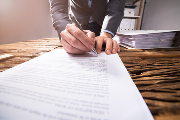 Businessperson Signing Document