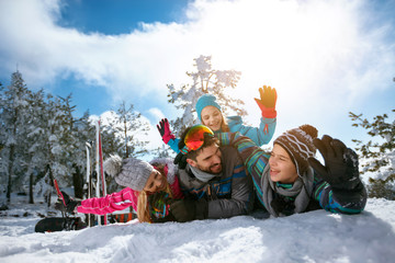 smiling family on winter vacation - Ski, snow, sun and fun